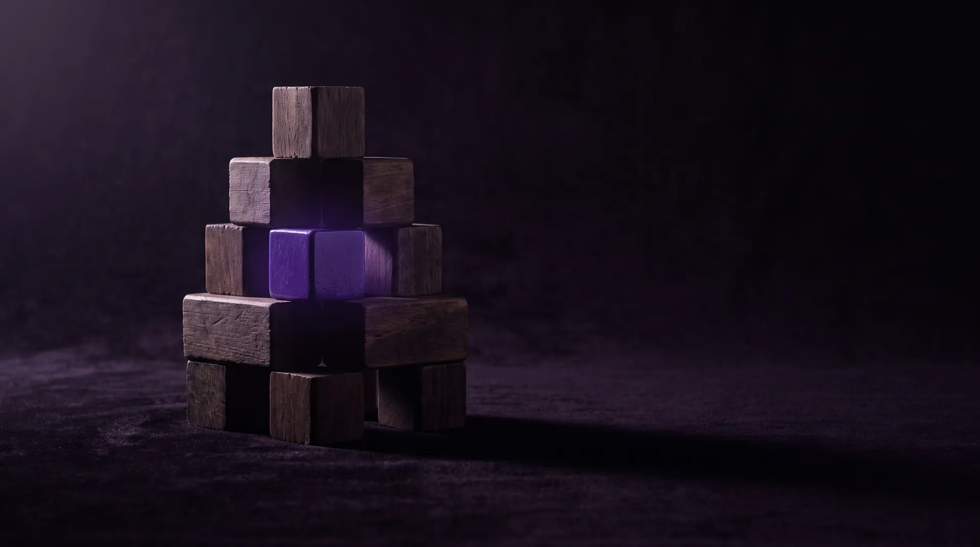 Puupalikoista koottu torni, jonka keskellä on violetti lukkokivi